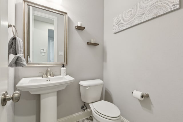 1600 Pebblebrook Ln, Prosper, TX 75078 - half bathroom with toilet, a sink, and baseboards
