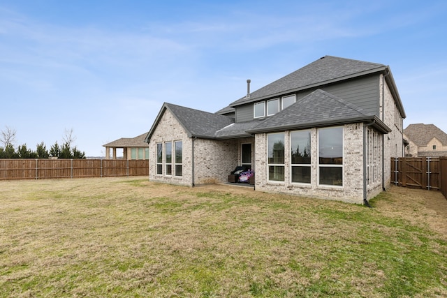 1600 Pebblebrook Ln, Prosper, TX 75078 - back of property featuring brick siding, a shingled roof, a fenced backyard, and a lawn