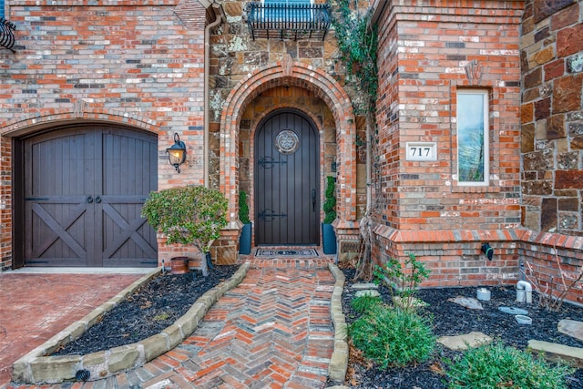 doorway to property with brick siding