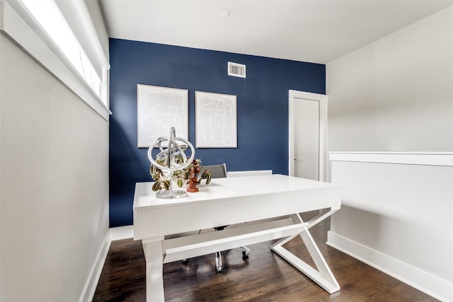 office area with visible vents, baseboards, and wood finished floors