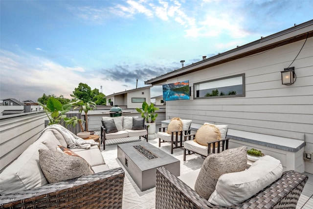 view of patio with an outdoor living space with a fire pit