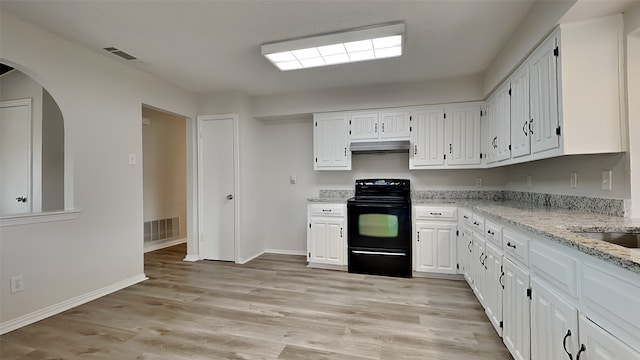 kitchen with white cabinetry, under cabinet range hood, visible vents, and black / electric stove