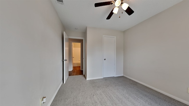 unfurnished bedroom with light carpet, ceiling fan, visible vents, and baseboards