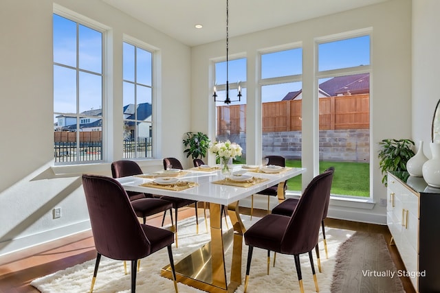 sunroom / solarium with an inviting chandelier