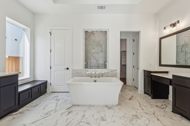 full bath with a marble finish shower, visible vents, a soaking tub, marble finish floor, and vanity