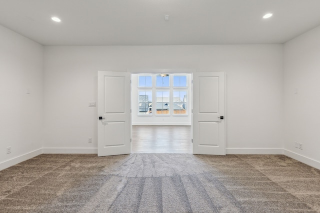 spare room featuring baseboards, carpet, and recessed lighting