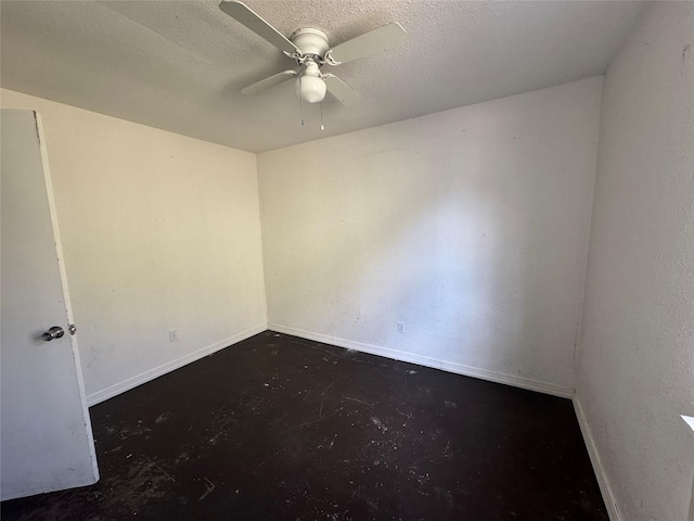 empty room with baseboards, concrete flooring, and a textured ceiling