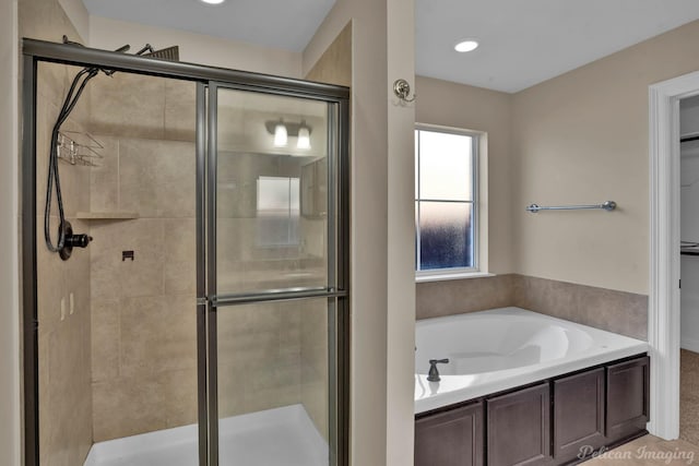 full bathroom featuring a garden tub and a shower stall