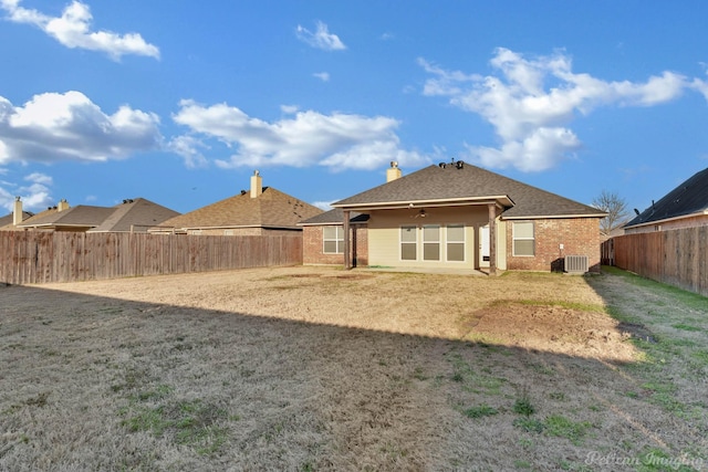 rear view of house featuring central AC, brick siding, ceiling fan, and a fenced backyard