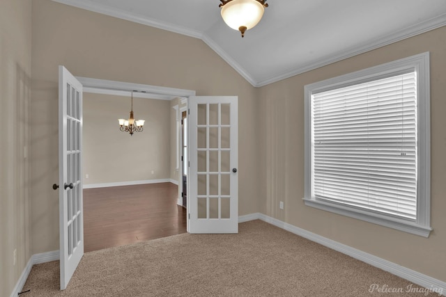 unfurnished room featuring a chandelier, lofted ceiling, french doors, and ornamental molding