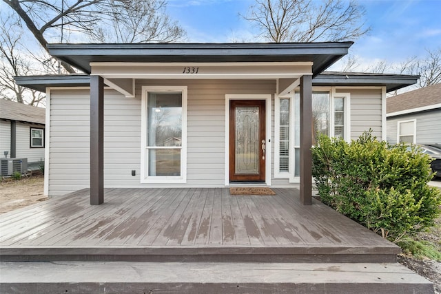 property entrance featuring a deck and central AC unit