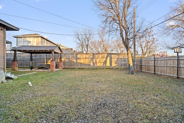 view of yard featuring a gazebo and a fenced backyard