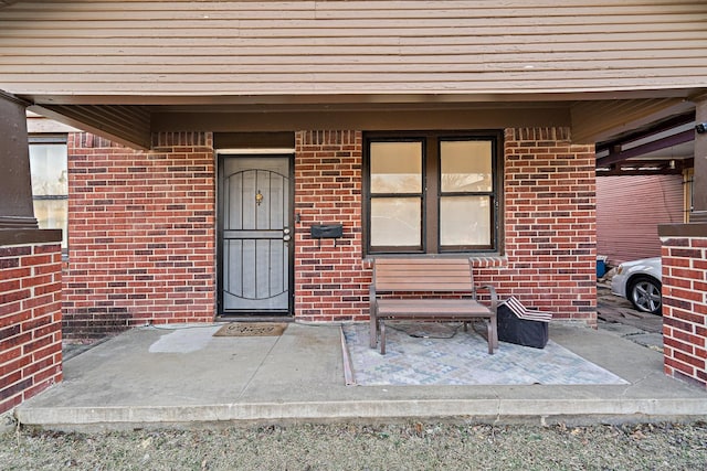 entrance to property with brick siding