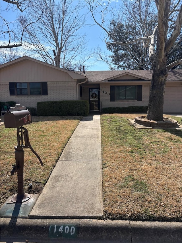 ranch-style house with brick siding and a front lawn