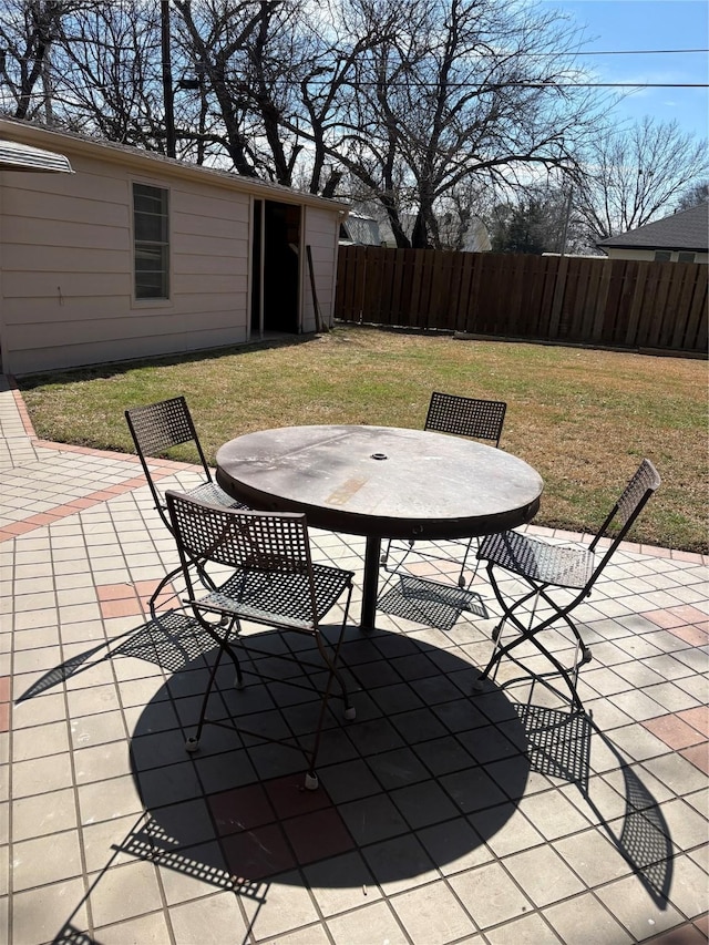 view of patio featuring outdoor dining area and fence