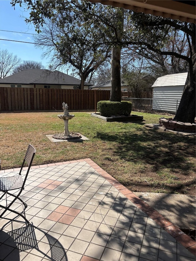 view of patio featuring an outbuilding, a storage shed, and a fenced backyard