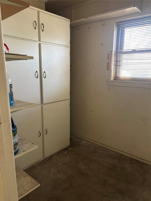 unfurnished bedroom featuring concrete flooring and a closet