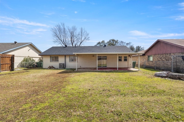 back of house with a yard, a patio area, a fenced backyard, and central air condition unit