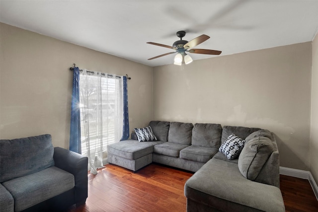 living room with ceiling fan, wood finished floors, and baseboards