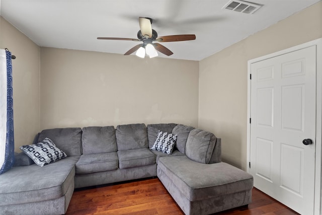 living area with ceiling fan, visible vents, and wood finished floors