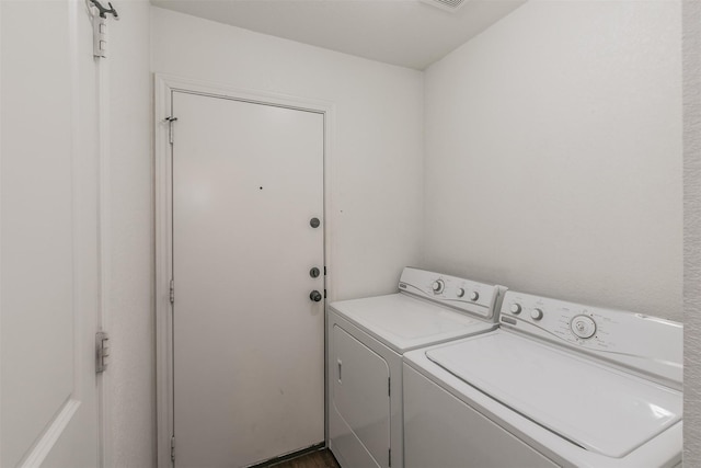 washroom featuring laundry area and washing machine and clothes dryer