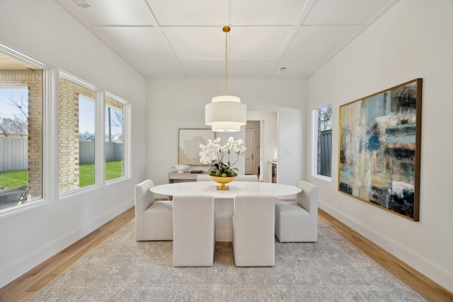 dining room with plenty of natural light, light wood-style flooring, and baseboards