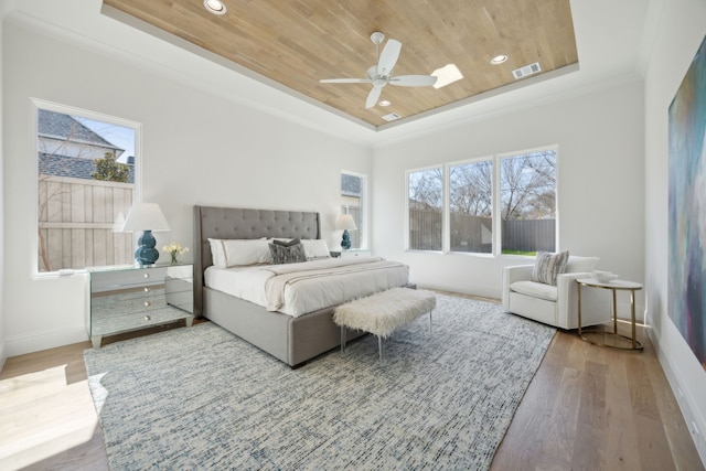 bedroom featuring a raised ceiling, visible vents, wood ceiling, wood finished floors, and baseboards