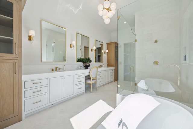 bathroom featuring a freestanding bath, a stall shower, vanity, and an inviting chandelier