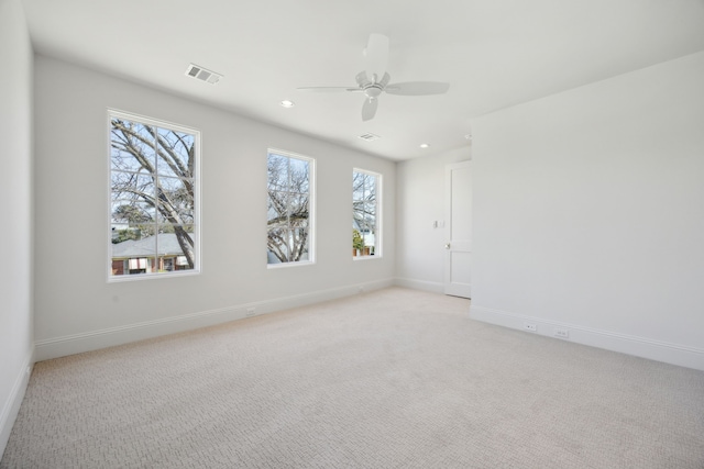 empty room featuring recessed lighting, light carpet, ceiling fan, and baseboards