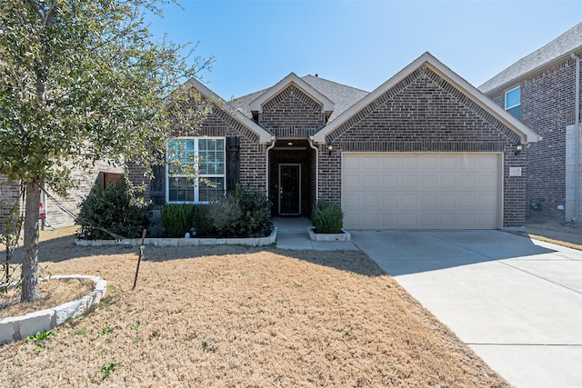 single story home with driveway, a garage, and brick siding