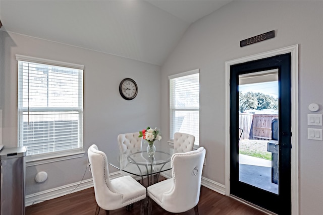 dining room with lofted ceiling, dark wood-type flooring, and baseboards