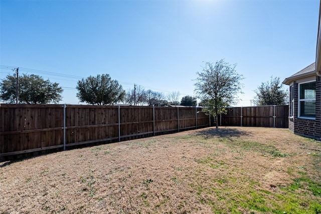 view of yard with a fenced backyard