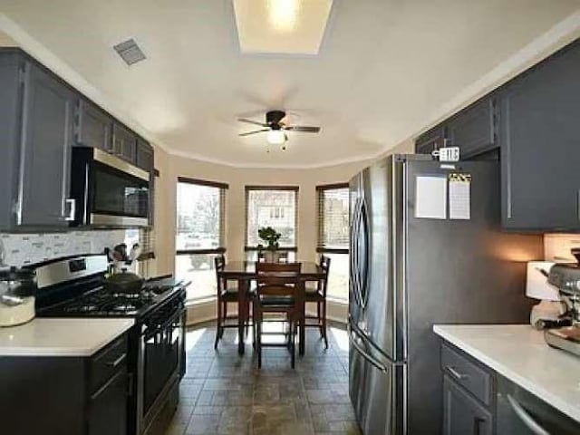 kitchen featuring appliances with stainless steel finishes, light countertops, visible vents, and ceiling fan