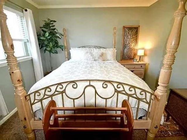 carpeted bedroom featuring ornamental molding