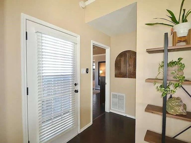 doorway to outside with dark wood-style floors and visible vents