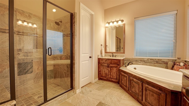 full bathroom with a stall shower, a bath, and vanity