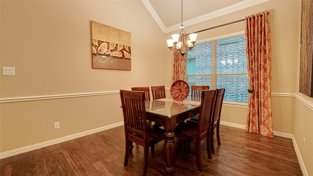 dining room with crown molding, vaulted ceiling, baseboards, and wood finished floors