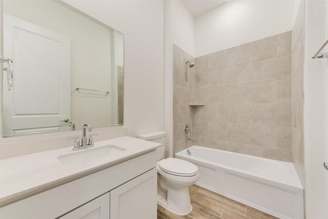 full bath with vanity, shower / washtub combination, wood finished floors, and toilet