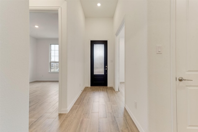 foyer with baseboards, recessed lighting, and light wood-style floors