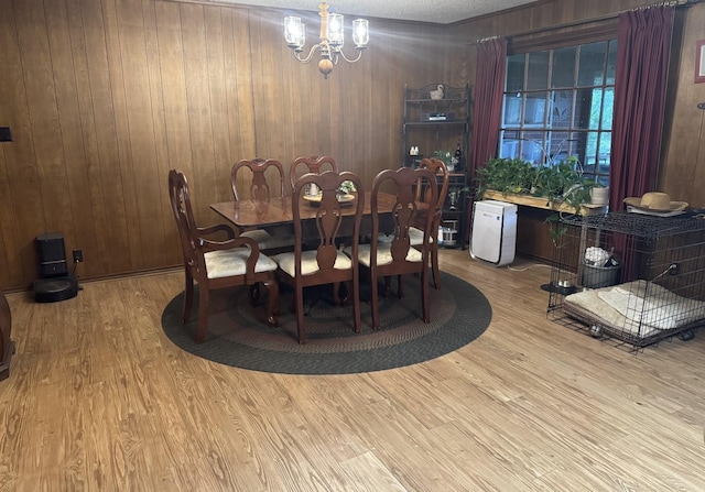 188 Walker Rd, Olney, TX 76374 - dining area with a chandelier, wood finished floors, and wood walls