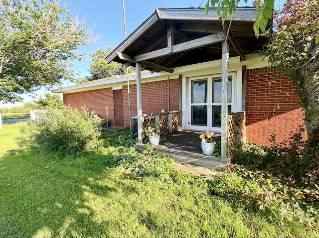 188 Walker Rd, Olney, TX 76374 - view of property exterior with brick siding and a lawn