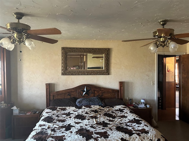 188 Walker Rd, Olney, TX 76374 - bedroom with a textured wall and a ceiling fan