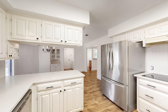 kitchen featuring an inviting chandelier, light countertops, light wood-style flooring, and appliances with stainless steel finishes