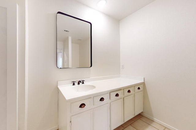 bathroom featuring baseboards, tile patterned floors, and vanity