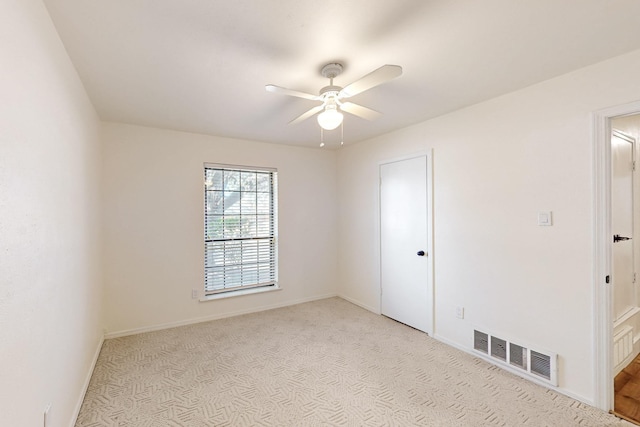 unfurnished room with a ceiling fan, baseboards, visible vents, and carpet flooring