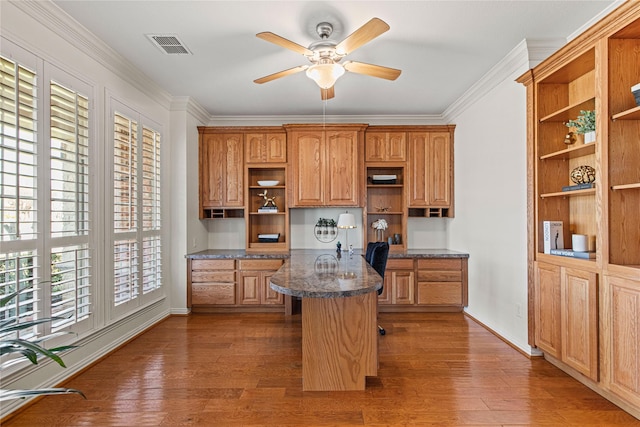 kitchen with open shelves, wood finished floors, and built in study area