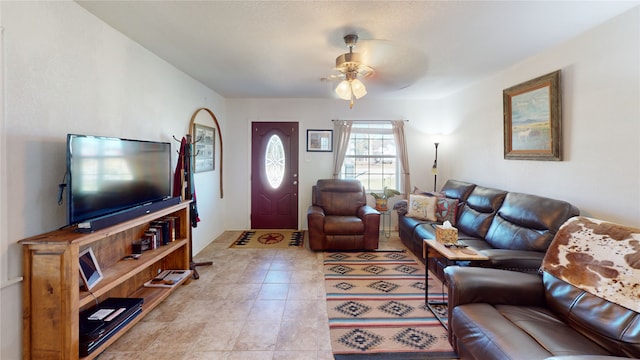 living area featuring ceiling fan and light tile patterned floors