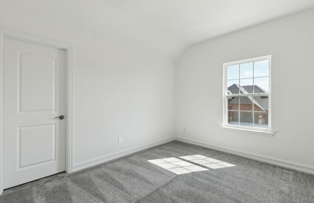 14574 Elion Ct, Pilot Point, TX 75009 - unfurnished room with carpet, lofted ceiling, and baseboards