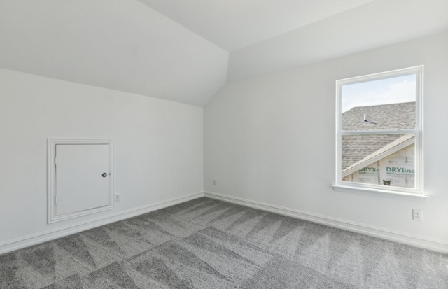 14574 Elion Ct, Pilot Point, TX 75009 - bonus room featuring vaulted ceiling, carpet floors, and baseboards