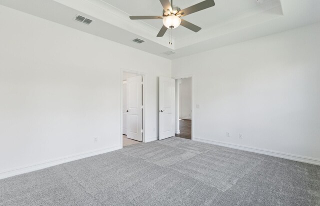 14574 Elion Ct, Pilot Point, TX 75009 - unfurnished room featuring a tray ceiling, visible vents, a ceiling fan, and light carpet